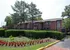 Flower bed with red blooms and hedges near buildings at Hickory Pointe in Memphis, TN