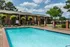 Pool deck with lounge chairs and brick buildings at Hickory Pointe in Memphis, TN