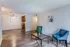 Living room with blue chairs and wood-style floors at Hickory Pointe in Memphis, TN