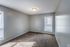 Carpeted bedroom with window at Deerfield Apartments in Memphis, TN