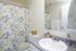 Bathroom with a patterned shower curtain and vanity at Braewood in Murray, UT