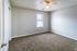 Carpeted second bedroom with window at Collier Village Apartments in Collierville, TN