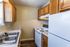 Kitchen with wood cabinets and white appliances at Collier Village Apartments in Collierville, TN