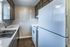 Kitchen with dark cabinets and white appliances at Collier Village Apartments in Collierville, TN