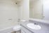 Bathroom with a tub-shower and white vanity at Fairbrook in Salt Lake City, UT