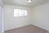 Carpeted bedroom with a single window at Fairbrook in Salt Lake City, UT