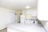 Kitchen and dining area with white appliances at Fairbrook in Salt Lake City, UT