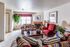 Furnished model living room with fireplace at Hickory Forest in Memphis, TN