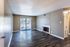 Living room with a fireplace and patio door at Hunter Oaks Apartments in Memphis, TN