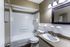 Bathroom with a tub-shower and dark-framed mirror at Hunter Oaks Apartments in Memphis, TN