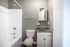 Bathroom with a tub-shower and white vanity at Jackson Heights Residential in West Memphis, AR
