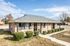 Single-story brick ranch home with shrubs at Jackson Heights Residential in West Memphis, AR