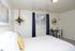 Bedroom with a queen bed and navy curtains at Linden Colonial in Holladay, UT