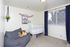 Second bedroom with a crib and a navy-curtained window at Linden Colonial in Holladay, UT