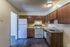 Kitchen with rich wood cabinets and white appliances in a 3 bedroom townhome at Shadowbrook Townhomes in Memphis, TN