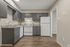 Kitchen with gray cabinets and white appliances at Shadowbrook Townhomes in Memphis, TN