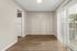 Dining area with wood-style floors and vertical blinds at Shadowbrook Townhomes in Memphis, TN