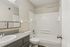 Bathroom with tub-shower combo and gray vanity at Shadowbrook Townhomes in Memphis, TN