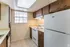 1 bedroom kitchen with dark wood cabinets and a bright window at Windsor Place Apartments in Memphis, TN