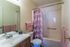 Primary bathroom with a pink shower curtain at Hickory Pointe in Memphis, TN