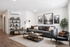 Modern living room with sleek gray couch, stylish wall art, and a cozy reading nook, perfect for relaxation.