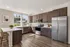 Modern kitchen with elegant wooden cabinets, stainless steel appliances, and sunlit countertops.