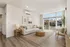 Bright and inviting living room with elegant decor, modern furnishings, and large windows offering scenic outdoor views.