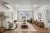 Bright and inviting living room featuring modern finishes, large window with natural light, and plank flooring..