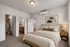 Elegant bedroom featuring a spacious walk-in closet with ample storage, and en suite bathroom.