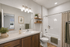 Elegant bathroom with modern fixtures, wooden cabinetry, and plank flooring.