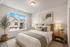 Bright and cozy bedroom featuring a walk-in closet, plush carpets, and large windows with uplifting views.