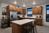 Modern kitchen with sleek wooden cabinets, stainless steel appliances, and a spacious island perfect for entertaining.