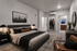 Luxurious bedroom featuring a modern grey bed, elegant decor, and a spacious walk-in closet with a stylish ensuite bathroom.