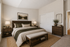 Elegant bedroom with cozy double bed, chic wooden furniture, and tranquil decor that invites relaxation.