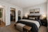 Elegant bedroom with cozy king-size bed, stylish decor, and a spacious walk-in closet for ample storage.
