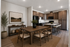 Elegant open-concept kitchen and dining area with modern wood cabinetry, stylish dining table, and cozy bar seating, perfect for entertaining.