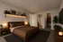 Elegant bedroom with modern decor, featuring a cozy bed, stylish bedside tables, ambient lighting, and a spacious en-suite bathroom.