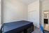 Bright bedroom with a comfortable bed, built-in closet, and a modern en-suite bathroom showcasing contemporary design.