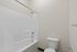 Pristine modern bathroom featuring a sleek tub and elegant design, offering a peaceful retreat.
