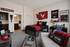 Charming student apartment with modern decor, featuring a cozy bed, a stylish study area, and vibrant university-themed accents.