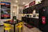 Inviting university-themed kitchen and dining area with vibrant yellow chairs, modern cabinetry, and stylish decor.