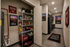 Modern apartment kitchen featuring sleek black appliances, a neatly organized pantry, and Eastern Washington University decor for a stylish touch.