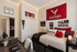 Cozy dorm room with Eastern Washington University decor, featuring a bed with university-themed pillows, a desk setup with a laptop, and ambient string lights.