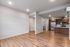 Modern open-concept living space with sleek hardwood floors and a gourmet kitchen featuring stainless steel appliances and stylish cabinetry.
