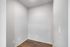 Modern apartment nook with sleek hardwood floors and minimalist white walls, perfect for a cozy workspace.