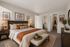 Modern bedroom in Bitterroot Lodge featuring elegant decor, cozy linens, and a spacious interior with walk-in closet and en-suite bathroom.