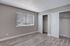 Bedroom with vinyl plank flooring, large window, and large double closets.