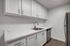 Open kitchen with white quartz countertops and white cabinets