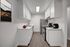 Renovated kitchen with stainless steel appliances and white quartz countertops