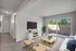 Open concept living room with slider leading to oversized enclosed patio